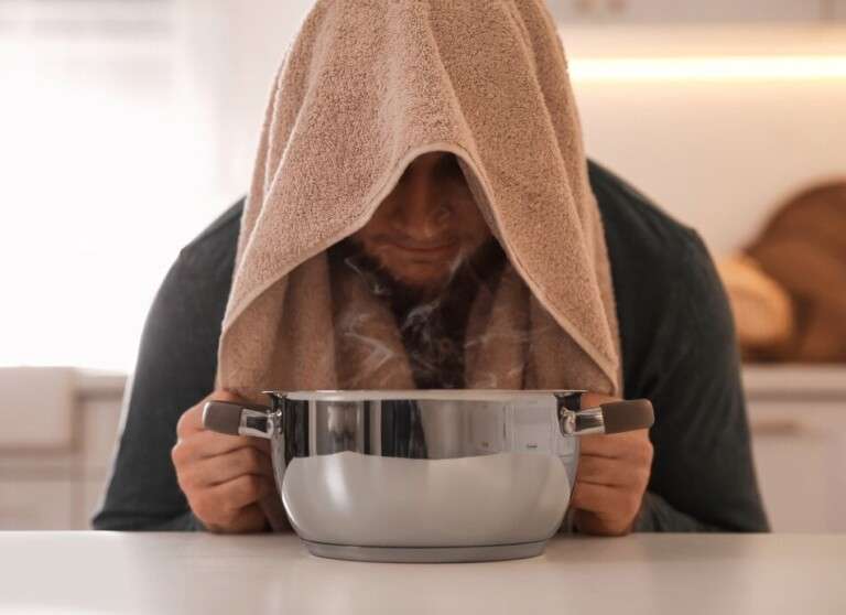 Man-inhaling-steam-canva-950x690