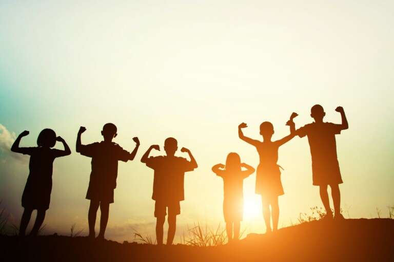 children-s-silhouettes-showing-muscles-sunset-2048x1365