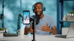Close-up-of-blogger-filming-video-with-smartphone-on-tripod-for-online-vlog