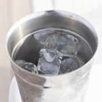 close-up-of-a-stainless-steel-cup-filled-with-ice-cubes-and--9036537
