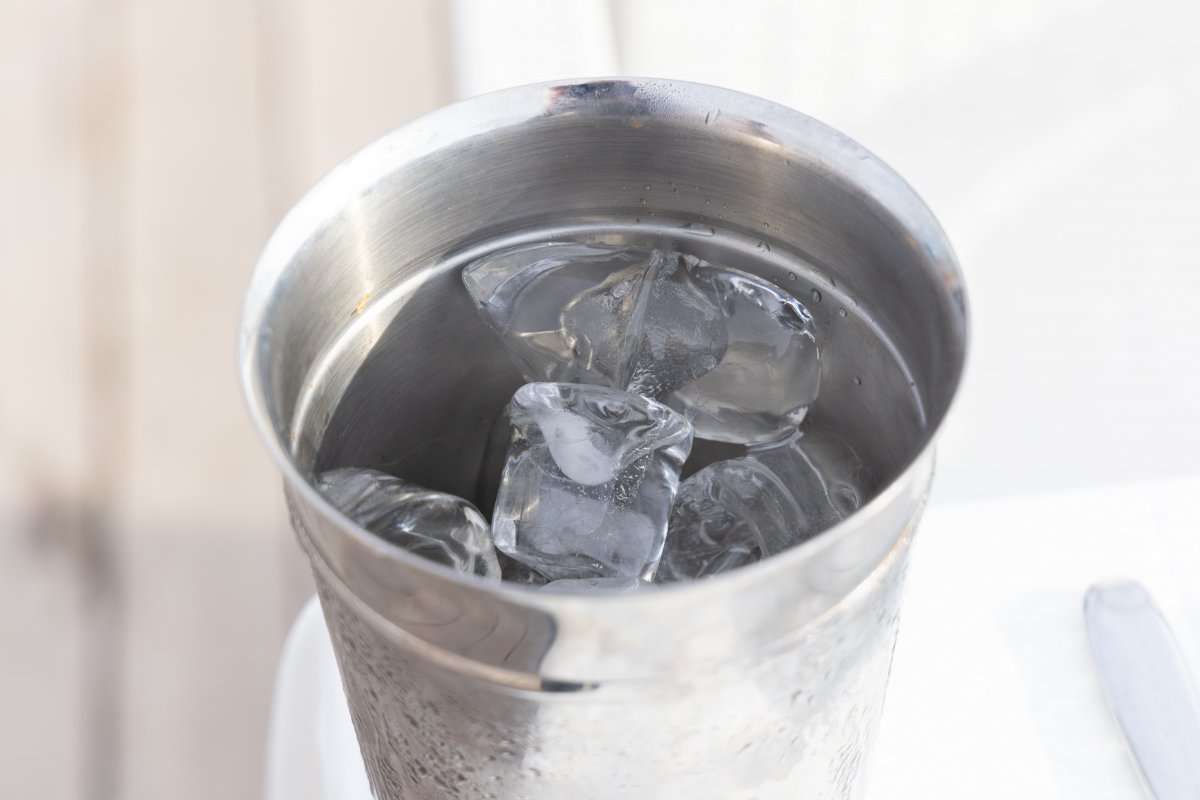 close-up-of-a-stainless-steel-cup-filled-with-ice-cubes-and--9036537