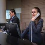 receptionists-phone-call-hotel-reception-woman-man-work-atte-5975962