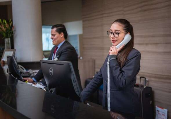 receptionists-phone-call-hotel-reception-woman-man-work-atte-5975962