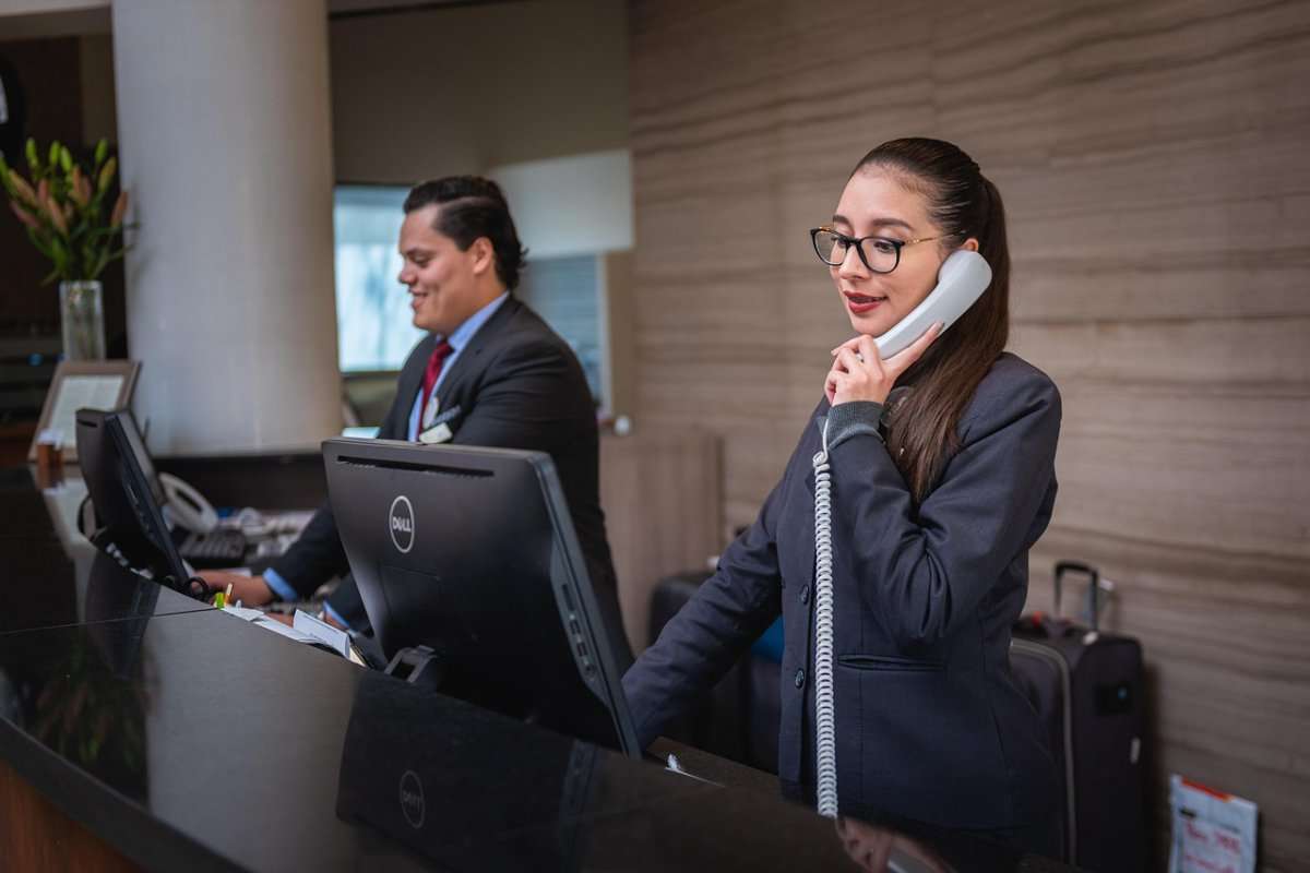 receptionists-phone-call-hotel-reception-woman-man-work-atte-5975962