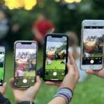 a-group-of-people-using-smartphones-to-photograph-an-outdoor-12860628