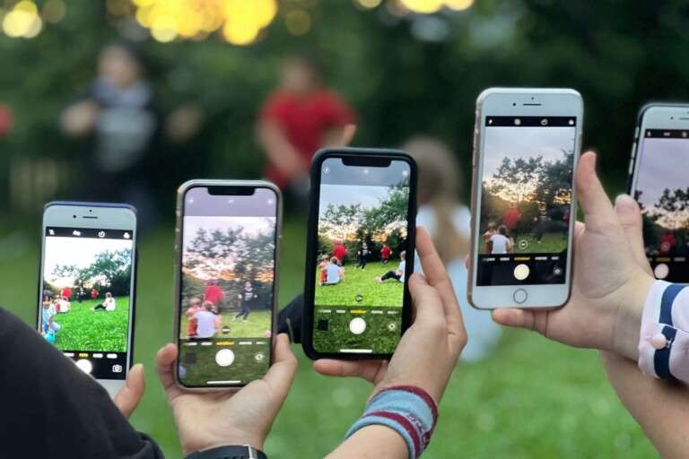 a-group-of-people-using-smartphones-to-photograph-an-outdoor-12860628
