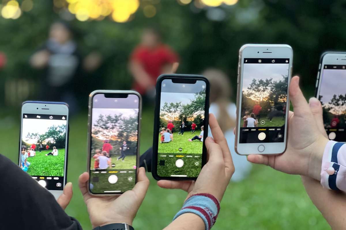 a-group-of-people-using-smartphones-to-photograph-an-outdoor-12860628