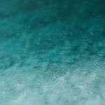 serene-teal-water-surface-with-ripples-and-raindrops-perfect-3394939