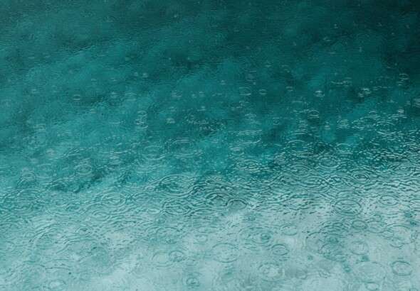 serene-teal-water-surface-with-ripples-and-raindrops-perfect-3394939